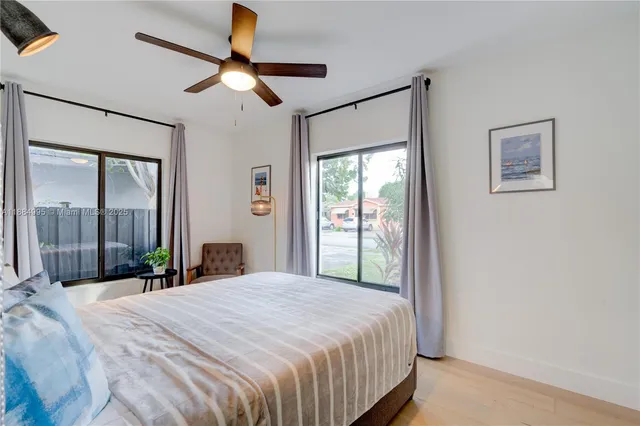 a bedroom with a large bed and a chandelier