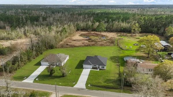 an aerial view of a house with a yard