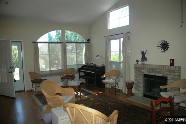 2789 Montego Drive Reno, NV 89523 - Photo 2 of 11 a living room with furniture a fireplace and large windows