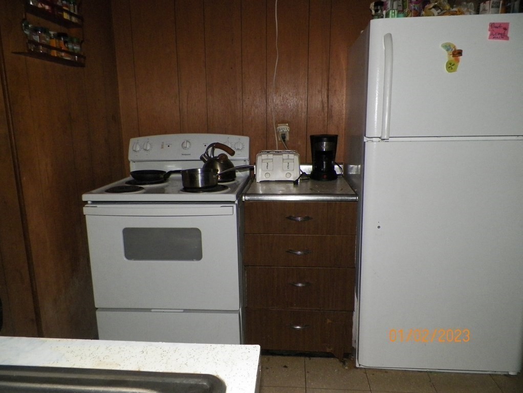 37 Prospect Street Webster, MA 01570 - Photo 5 of 20 a white refrigerator freezer sitting inside of a kitchen
