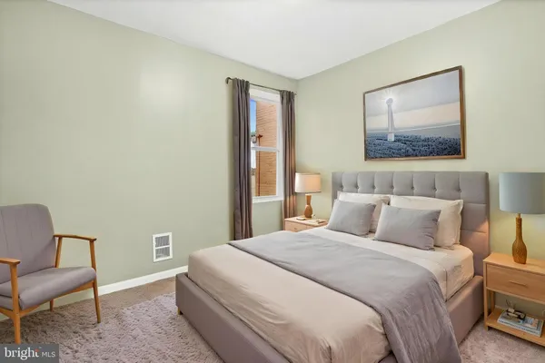 a bedroom with a bed and a chair