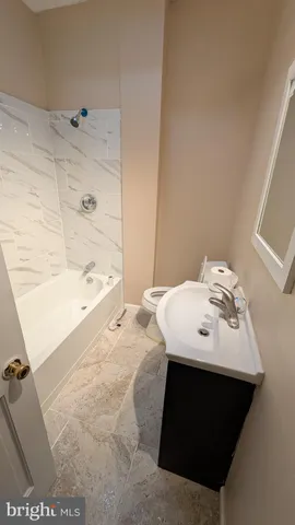 a view of a room with wooden floor and entryway
