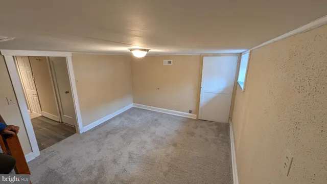 a view of a hallway with wooden floor and entryway