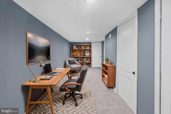 a workspace with furniture and a flat screen tv