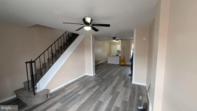 a view of a hallway with wooden floor and staircase