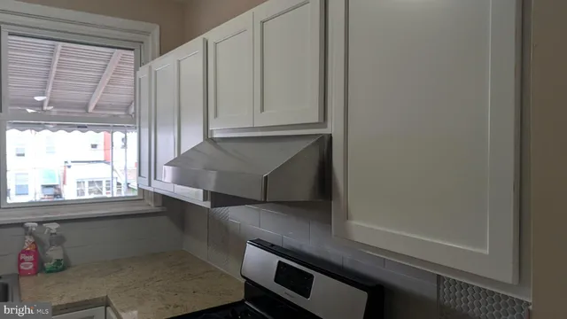 a kitchen with a window and cabinets