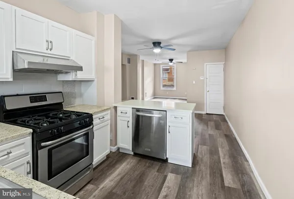 a kitchen with stove and cabinets