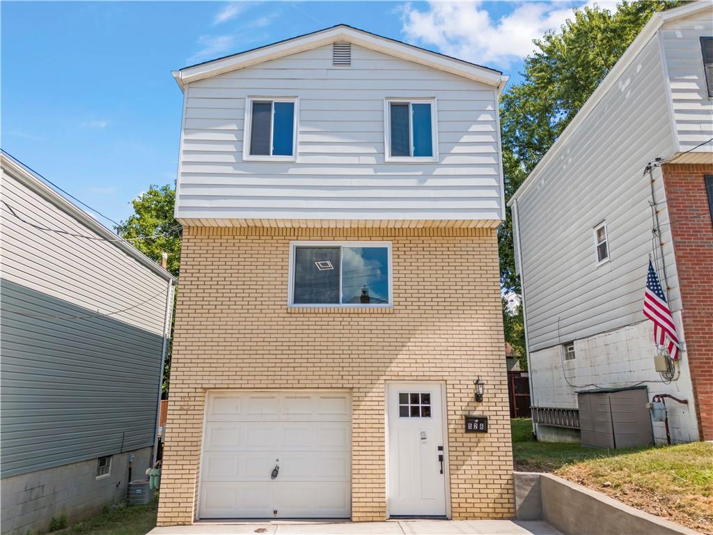 a front view of a house with a wooden fence