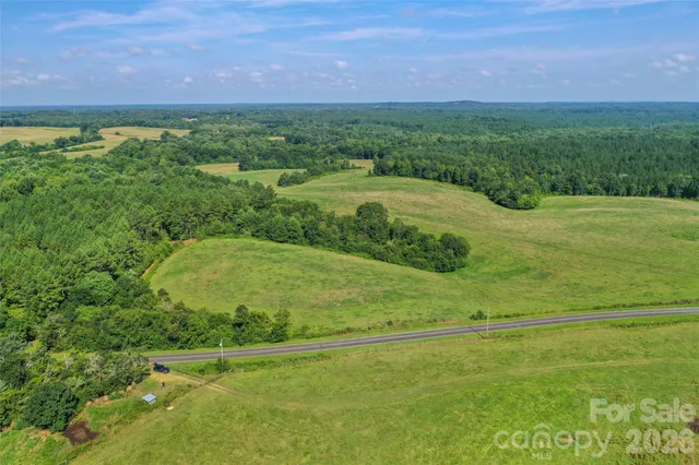 a view of a big yard with lots of green space