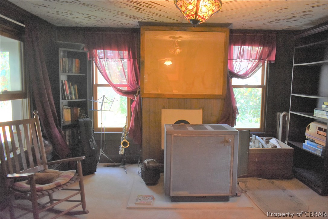 186 Aarons Bch Road Diggs, VA 23045 - Photo 13 of 40 Family room with lots of windows, newly lined chimney, all wood tongue and groove herringbone pattern ceiling.