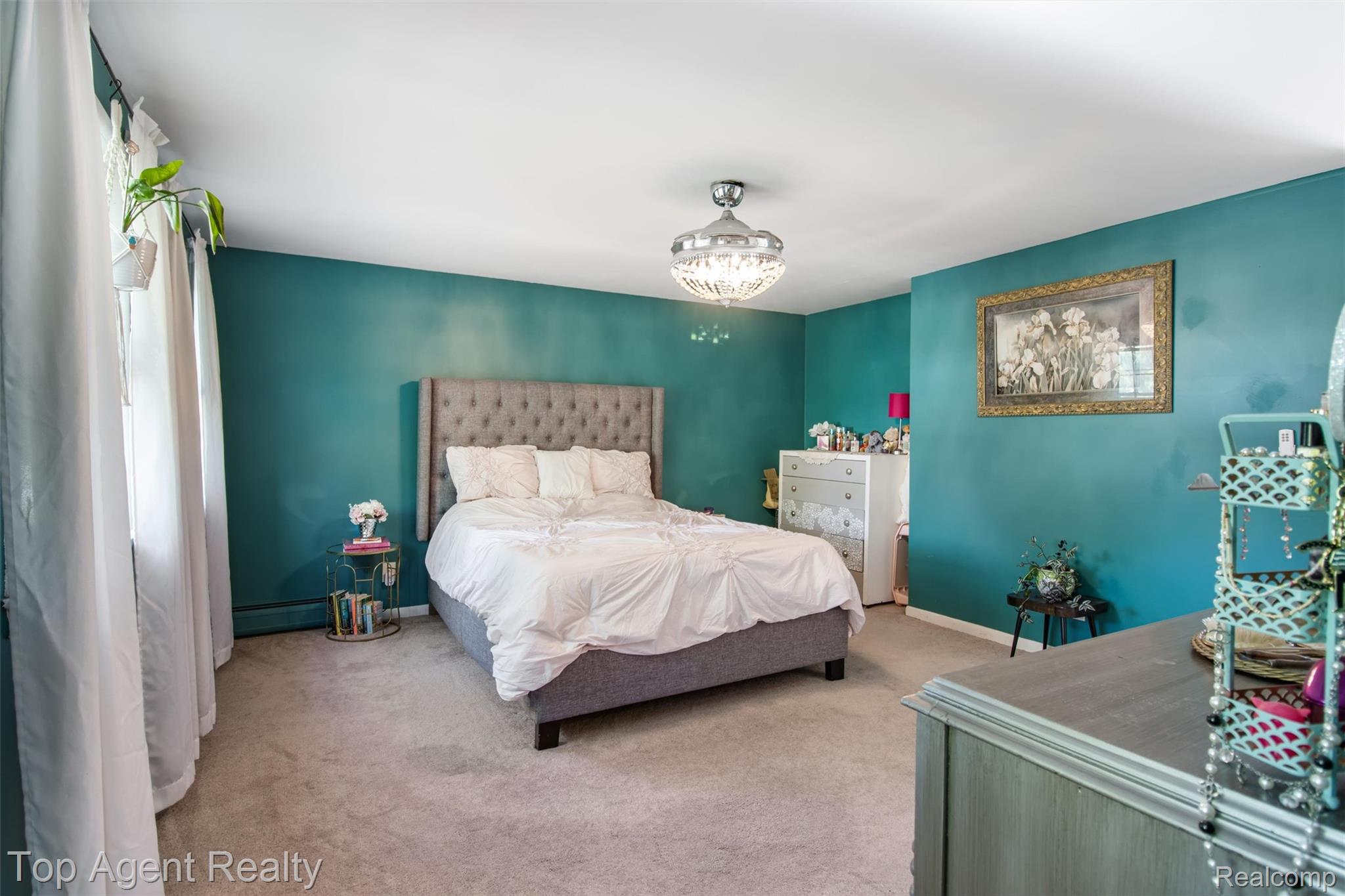 32341 Woody Road Fraser, MI 48026 - Photo 19 of 47 Spacious bedroom featuring light-colored carpeting, vibrant teal walls, and a contemporary ceiling light fixture