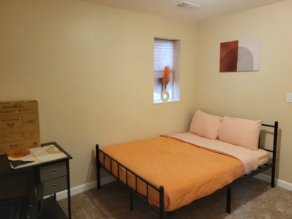 a bedroom with a bed and a desk
