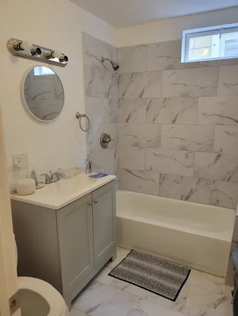 a bathroom with a sink a toilet and bathtub