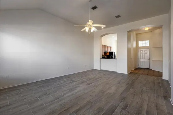 wooden floor in an empty room with a window
