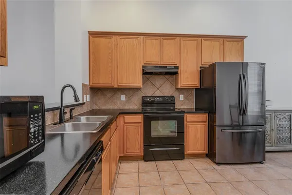 a kitchen with a refrigerator and a sink
