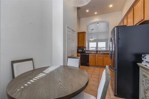 a kitchen with stainless steel appliances granite countertop a refrigerator a stove and a sink