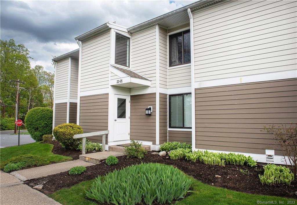 22 Olcott Way, Unit 22 Ridgefield, CT 06877 - Photo 1 of 1 a front view of a house with garden