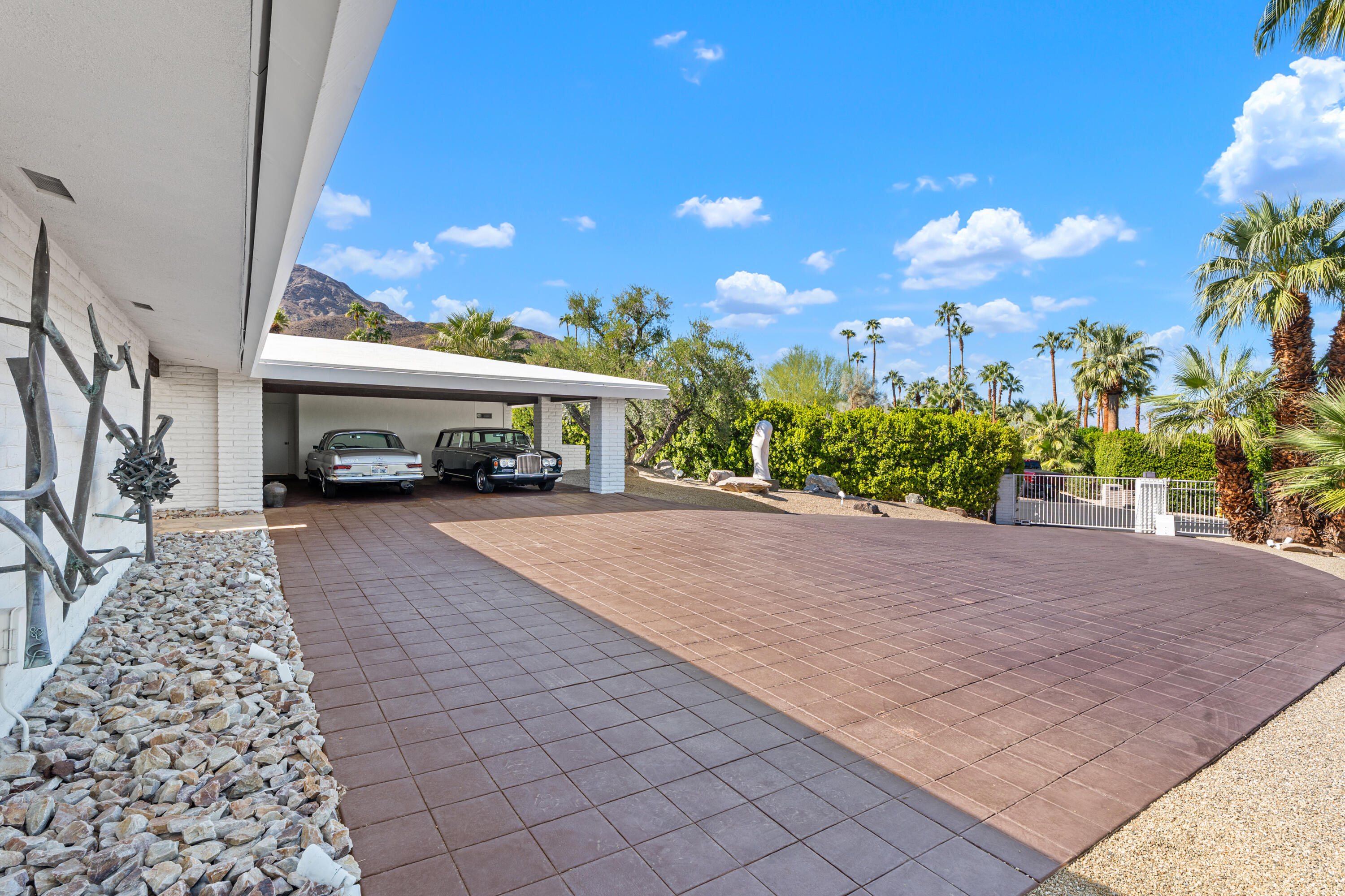 40286 Tonopah Road Rancho Mirage, CA 92270 - Photo 4 of 49 a view of a house with a yard and potted plants