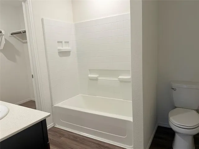 a bathroom with a bathtub and a toilet