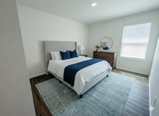 a bed sitting in a bedroom next to a window