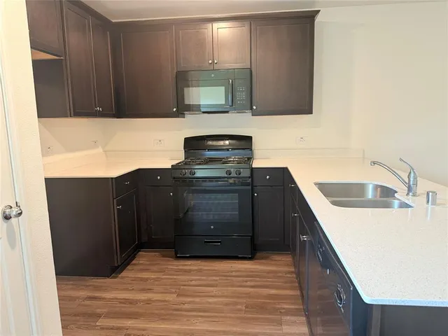 a kitchen with a sink and a stove top oven