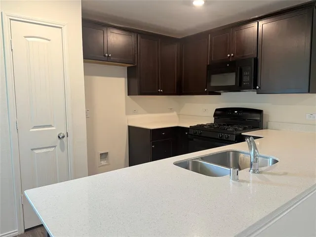 a kitchen with a sink and a refrigerator