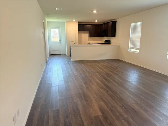 a view of kitchen with wooden floor and electronic appliances