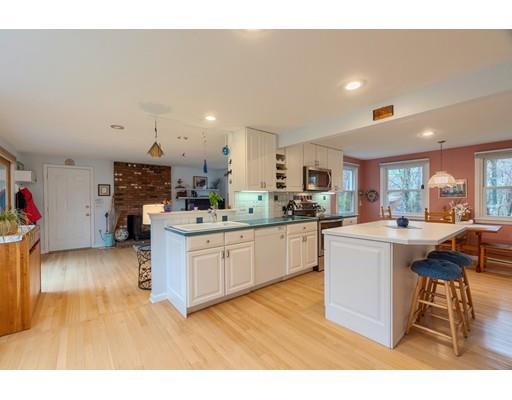 149 Beaman Road Princeton, MA 01541 - Photo 11 of 31 a kitchen with a sink dishwasher a stove a dining table and chairs with wooden floor