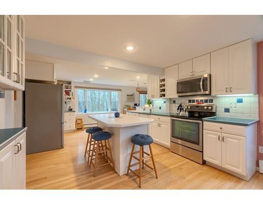149 Beaman Road Princeton, MA 01541 - Photo 12 of 31 a kitchen with stainless steel appliances granite countertop a refrigerator a stove top oven a sink dishwasher and white cabinets with wooden floor