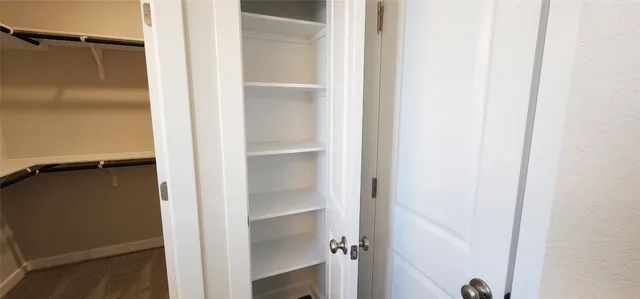 a bathroom with a granite countertop toilet and a shower