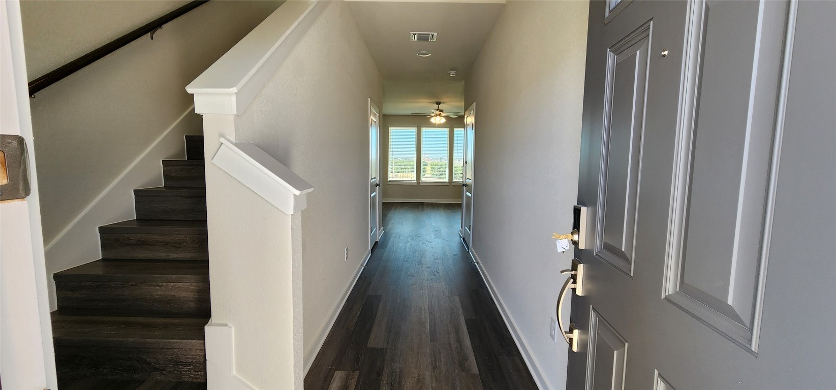 2232 Delano Drive Leander, TX 78641 - Photo 2 of 36 a view of a hallway with wooden floor and staircase
