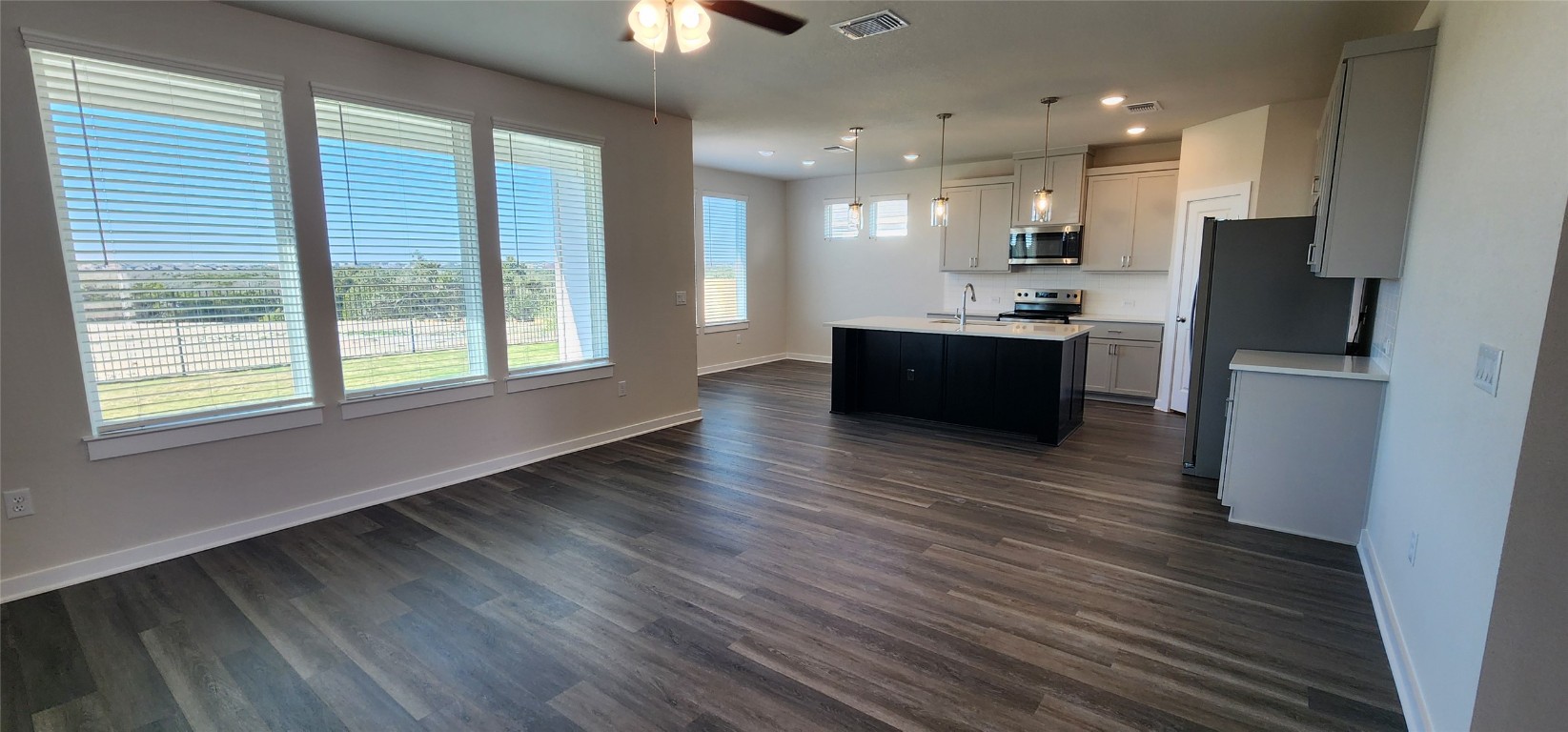 2232 Delano Drive Leander, TX 78641 - Photo 35 of 36 a large kitchen with stainless steel appliances wooden floors and wooden cabinets