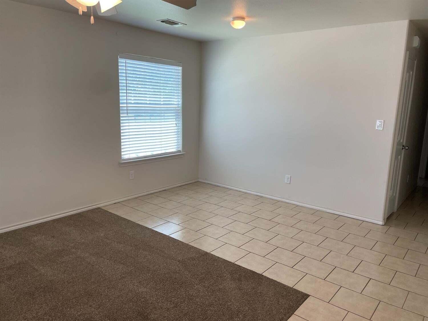 8912 Terrell Avenue Lubbock, TX 79423 - Photo 5 of 11 an empty room with a window