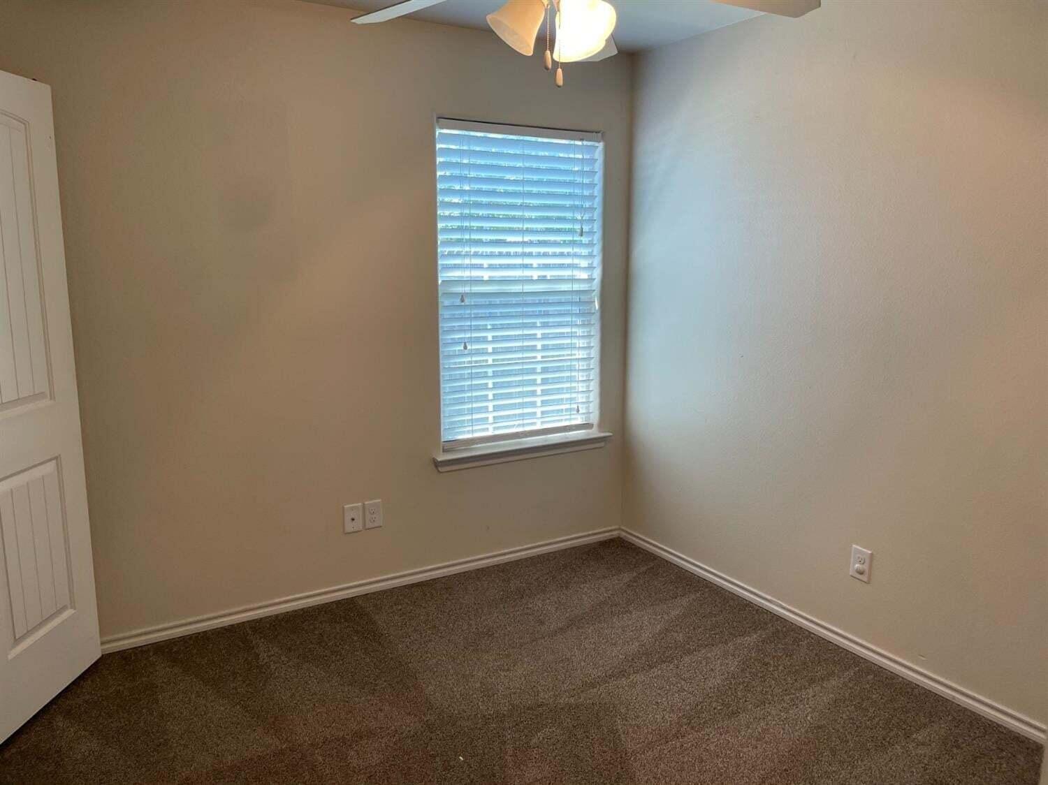 8912 Terrell Avenue Lubbock, TX 79423 - Photo 9 of 11 an empty room with a window