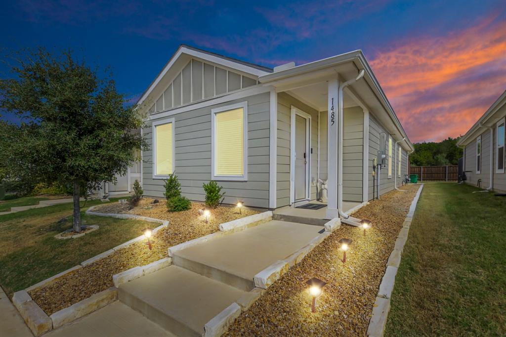 a view of house with backyard and swimming pool