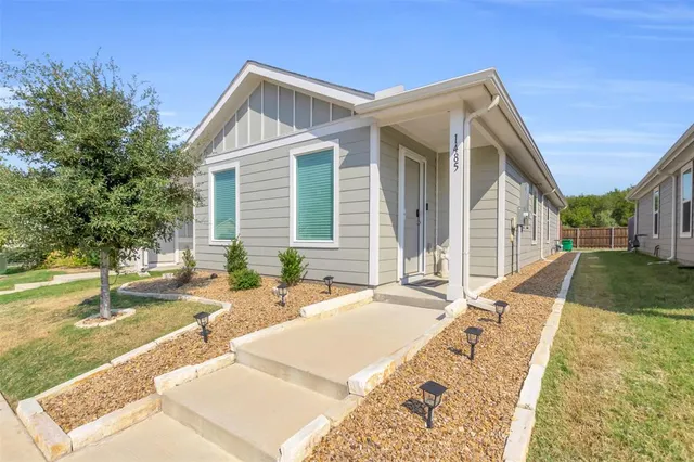 a view of a house with backyard and sitting area
