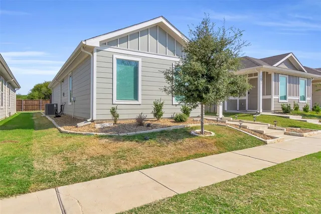 a view of a house with swimming pool and next to a yard