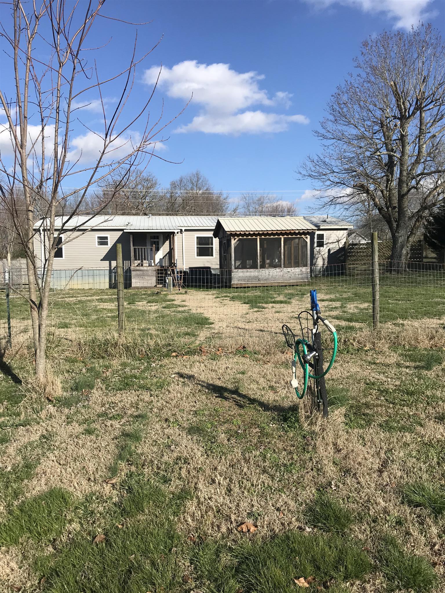 873 Prosser Road Leoma, TN 38468 - Photo 24 of 25 a backyard of a house with barbeque oven table and chairs