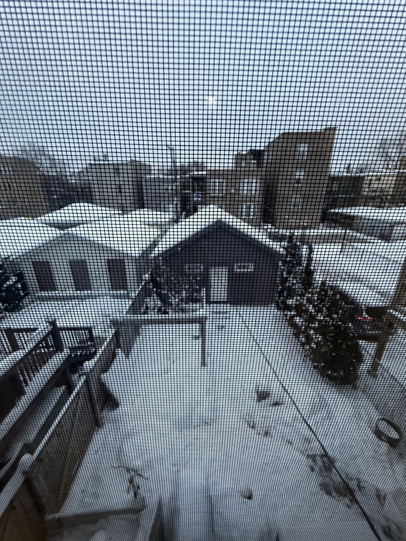 3252 West Crystal Street, Unit 2 Chicago, IL 60651 - Photo 13 of 13 a view of a brick building with wooden fence