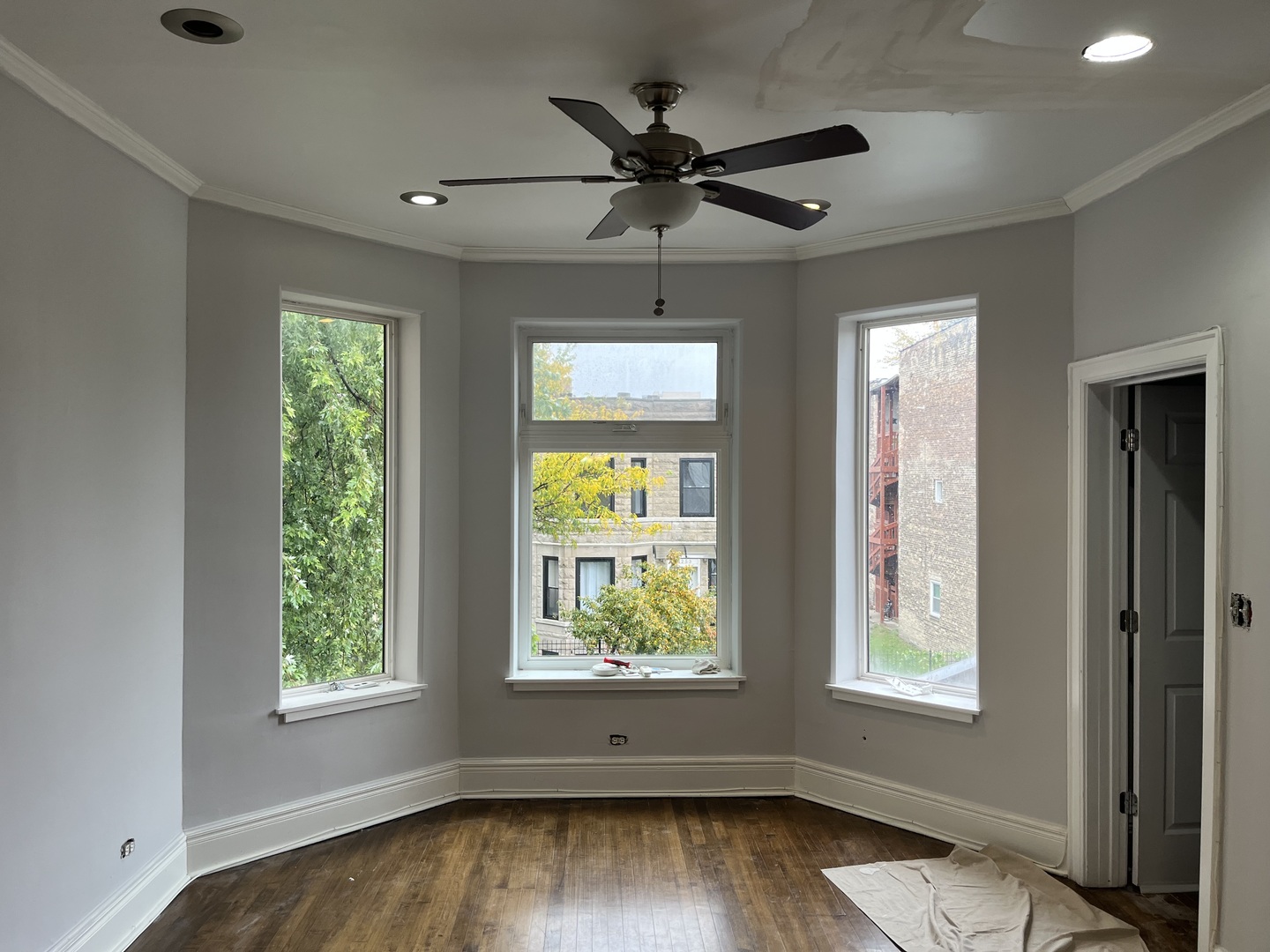 3252 West Crystal Street, Unit 2 Chicago, IL 60651 - Photo 3 of 13 a view of an empty room with wooden floor and a window