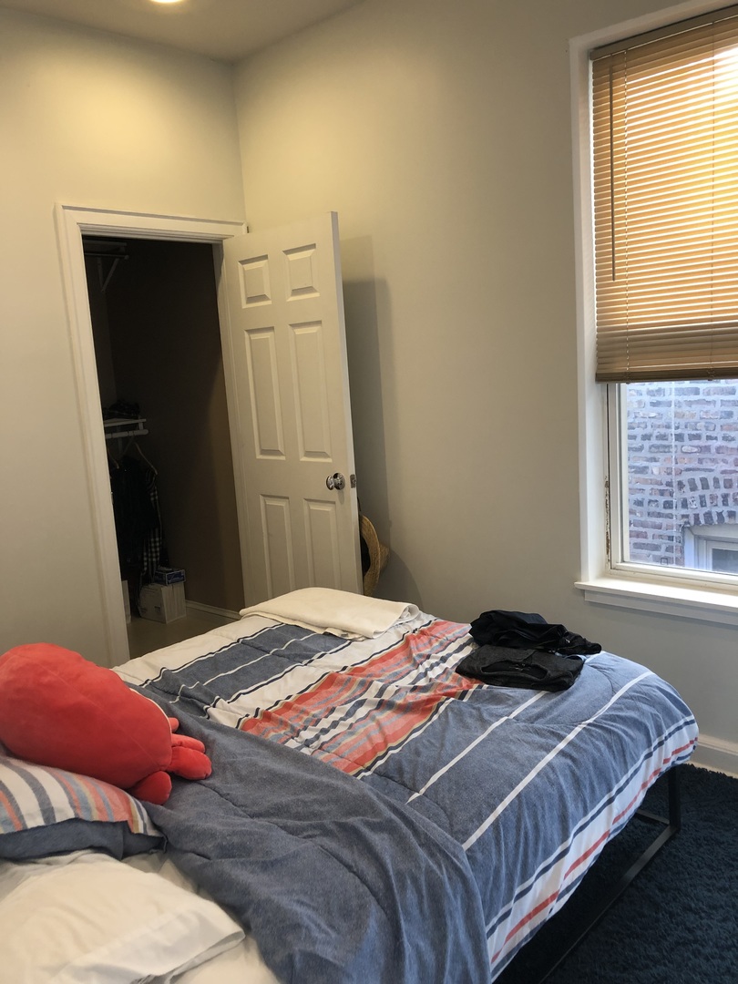 3252 West Crystal Street, Unit 2 Chicago, IL 60651 - Photo 9 of 13 a bedroom with a bed and a window