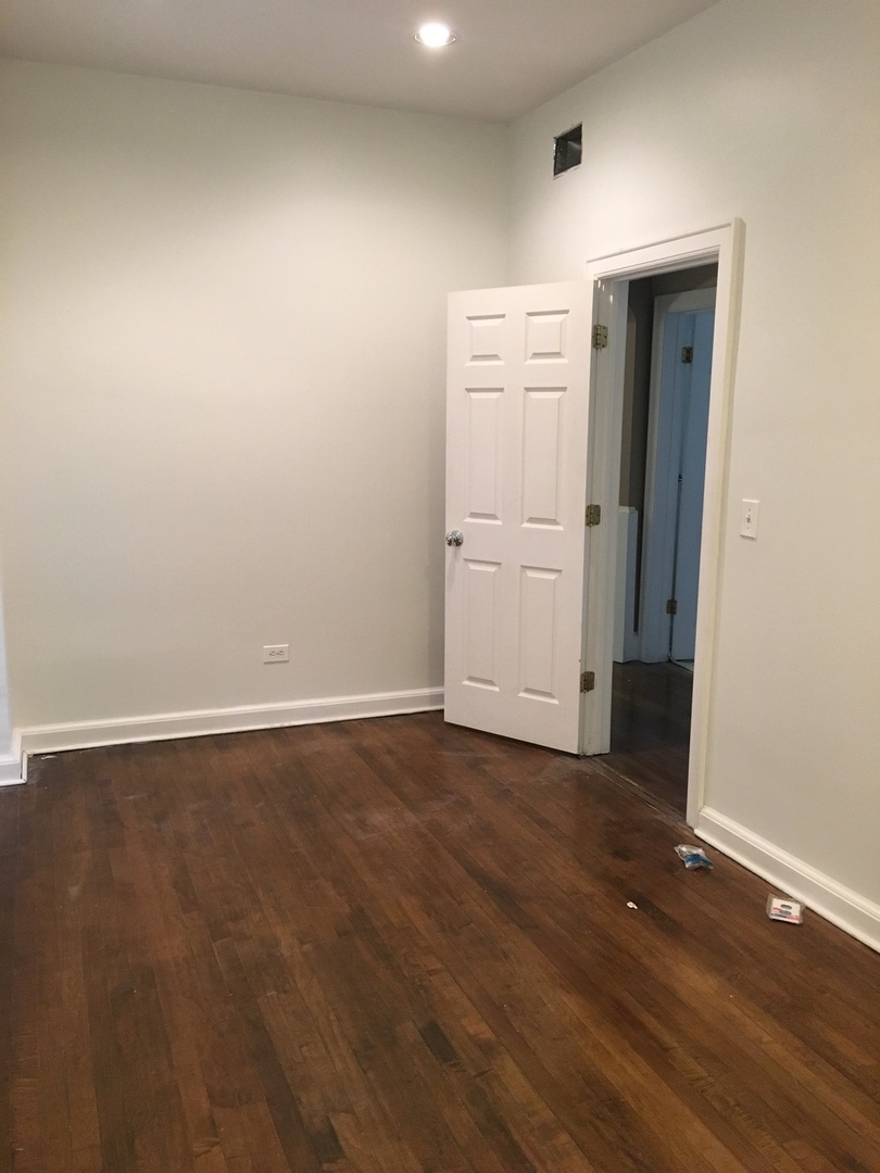 3252 West Crystal Street, Unit 2 Chicago, IL 60651 - Photo 10 of 13 wooden floor in an empty room