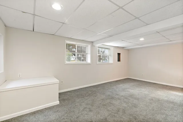 a view of a room with a white walls and a toilet