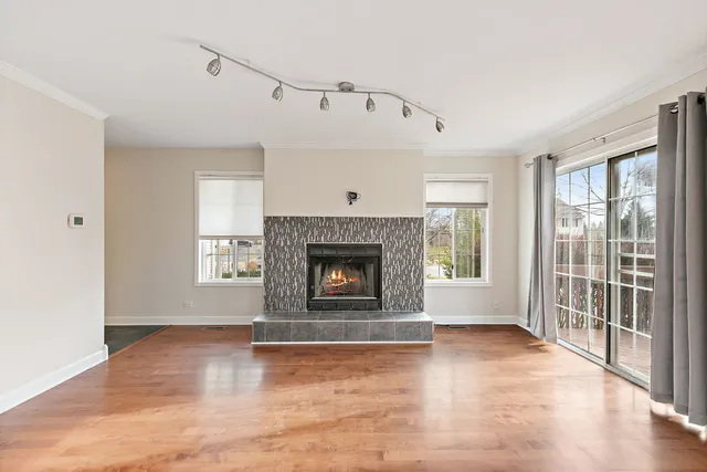 a view of an empty room with a fireplace and a window