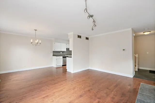 a view of a kitchen with a sink and wooden floor