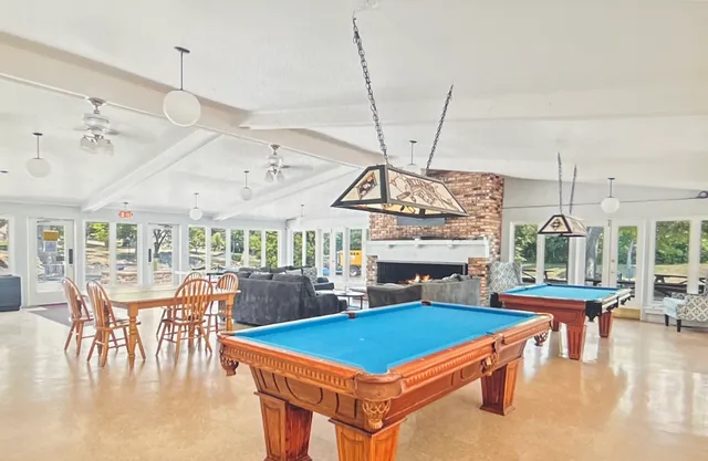 a living room with lots of furniture and a chandelier