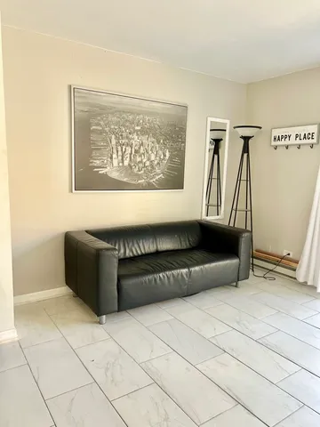 a living room with a couch and a rug