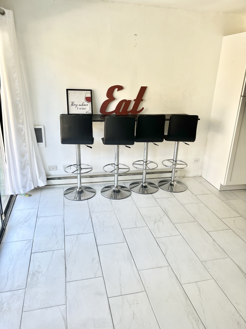 40 Bermuda Colony, Unit 7 Fox Lake, IL 60020 - Photo 6 of 20 a view of a terrace with chairs and wooden floor