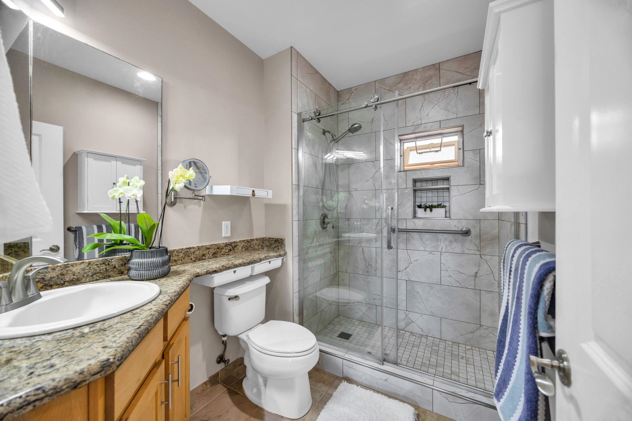3708 Lower Honoapiilani Road, Unit E33 Lahaina, HI 96761 - Photo 22 of 36 a bathroom with a granite countertop sink toilet and shower