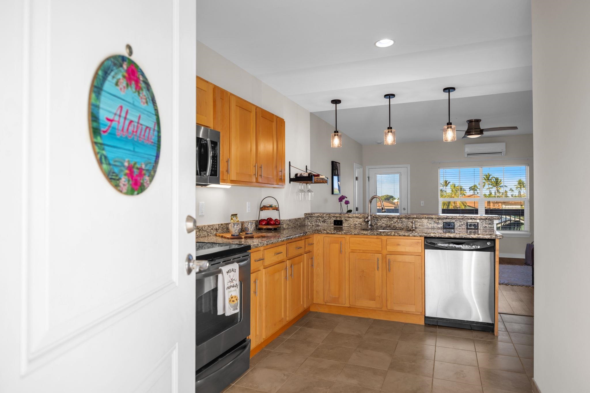 3708 Lower Honoapiilani Road, Unit E33 Lahaina, HI 96761 - Photo 3 of 36 a kitchen with stainless steel appliances granite countertop a sink stove and refrigerator